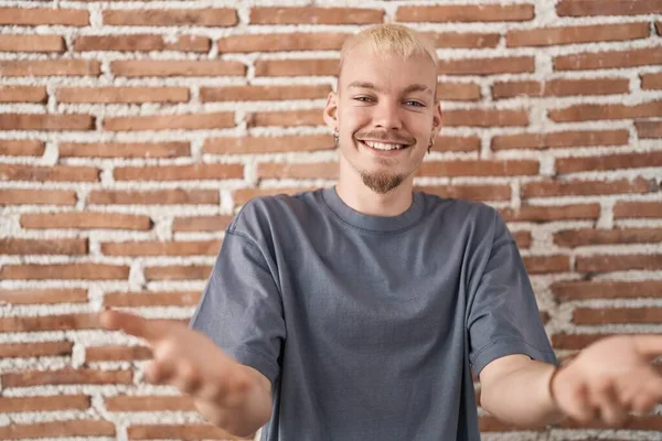 Young Caucasian Man Standing Bricks Wall Smiling Cheerful Offering Hands —  Fotos de Stock