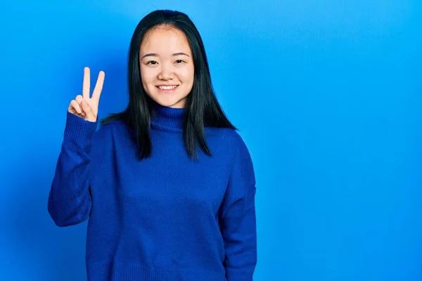 Young Chinese Girl Wearing Casual Clothes Showing Pointing Fingers Number — 스톡 사진