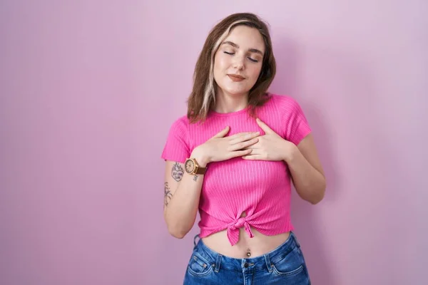 Blonde Caucasian Woman Standing Pink Background Smiling Hands Chest Closed — Stock Fotó