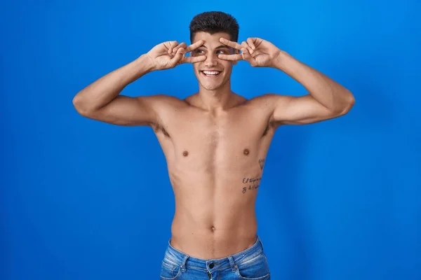 Young Hispanic Man Standing Shirtless Blue Background Doing Peace Symbol — Fotografia de Stock