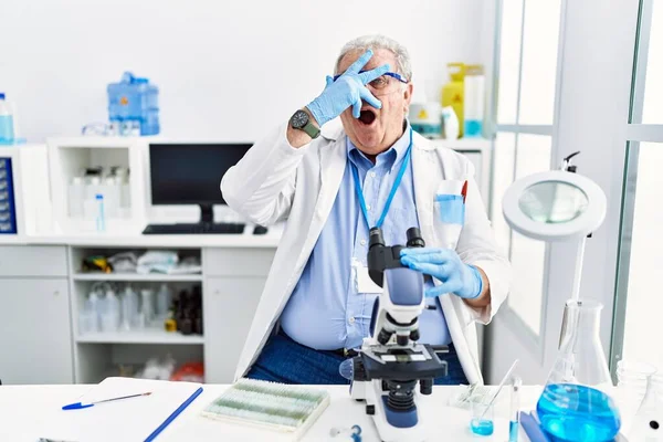 Senior Caucasian Man Working Scientist Laboratory Peeking Shock Covering Face — Zdjęcie stockowe