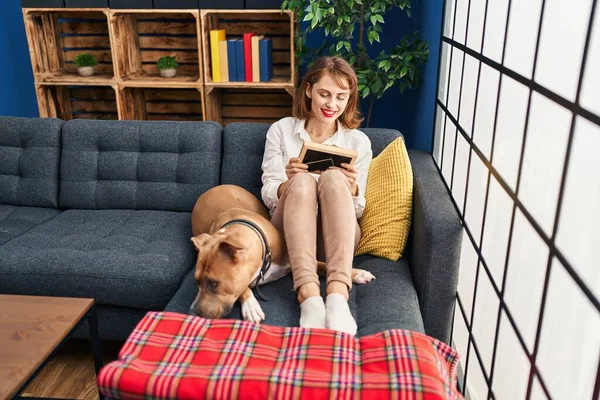 Young Caucasian Woman Looking Photo Sitting Sofa Dog Home — Foto de Stock