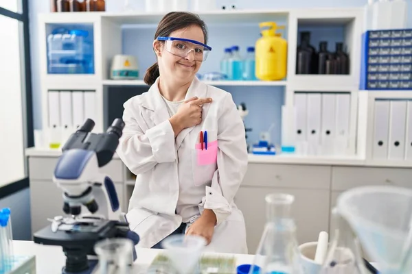 Hispanic Girl Syndrome Working Scientist Laboratory Cheerful Smile Face Pointing — Fotografia de Stock