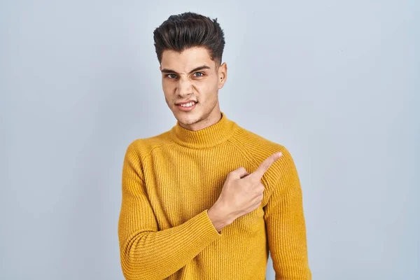 Young Hispanic Man Standing Blue Background Pointing Aside Worried Nervous — 스톡 사진