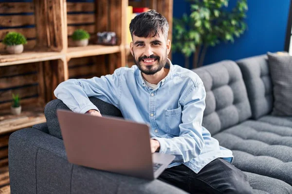 Young Hispanic Man Using Laptop Sitting Sofa Home —  Fotos de Stock