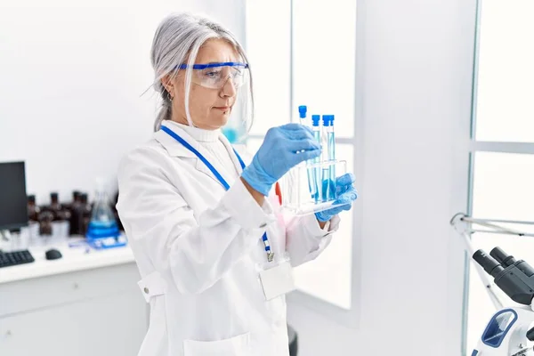 Middle Age Grey Haired Woman Wearing Scientist Uniform Using Laptop — Stock Photo, Image