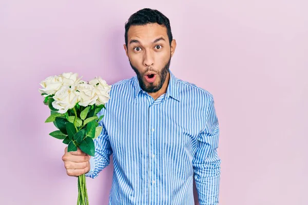 Hispanic Man Beard Holding Bouquet White Flowers Scared Amazed Open — Stock fotografie