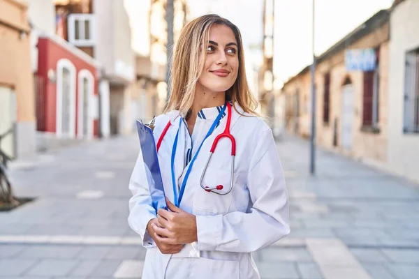 Young Blonde Woman Wearing Doctor Uniform Holding Checklist Street — Fotografia de Stock