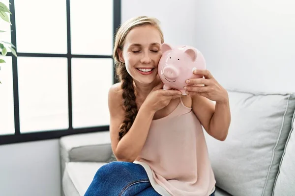 Young Caucasian Woman Holding Piggy Bank Sitting Sofa Home — Fotografia de Stock