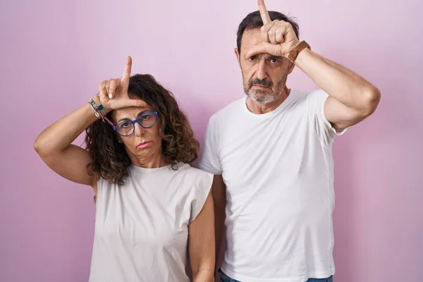 Middle Age Hispanic Couple Together Pink Background Making Fun People — Stockfoto