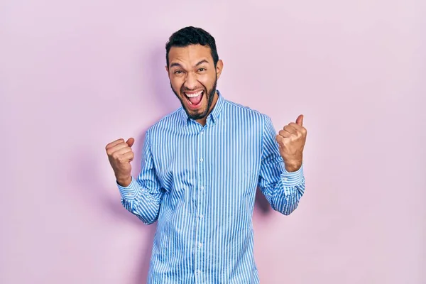 Hispanic Man Beard Wearing Casual Blue Shirt Celebrating Surprised Amazed — Fotografia de Stock