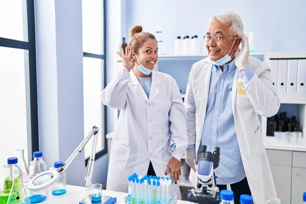 Middle Age Hispanic People Working Scientist Laboratory Smiling Hand Ear — ストック写真