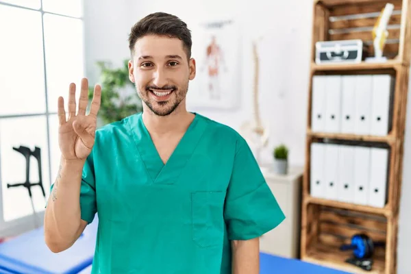 Young Physiotherapist Man Working Pain Recovery Clinic Showing Pointing Fingers — Stockfoto