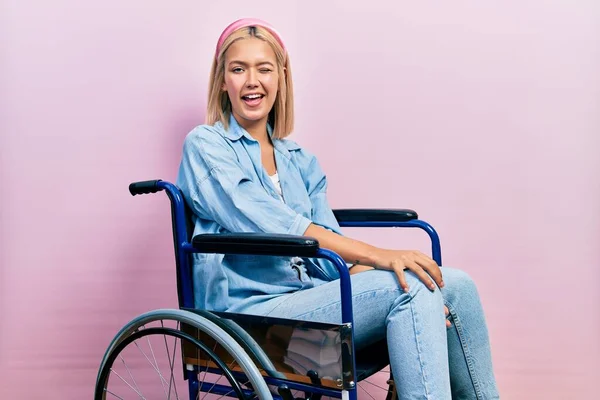 Beautiful Blonde Woman Sitting Wheelchair Winking Looking Camera Sexy Expression — Stok fotoğraf