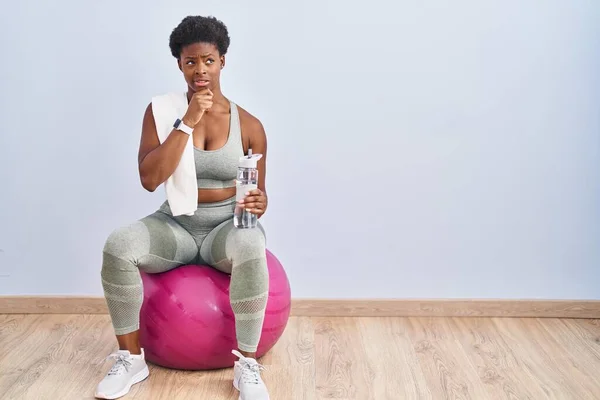 African American Woman Wearing Sportswear Sitting Pilates Ball Thinking Worried — Stockfoto