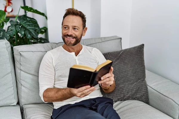 Middle Age Hispanic Man Smiling Confident Reading Book Home — Stok fotoğraf