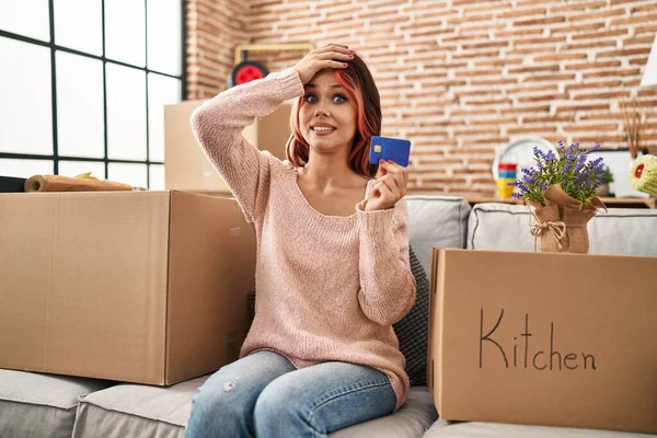 Young Caucasian Woman Moving New Home Holding Credit Card Stressed — Foto de Stock
