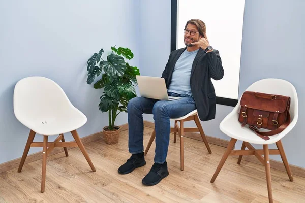 Handsome Middle Age Man Sitting Waiting Room Working Laptop Smiling — Fotografia de Stock