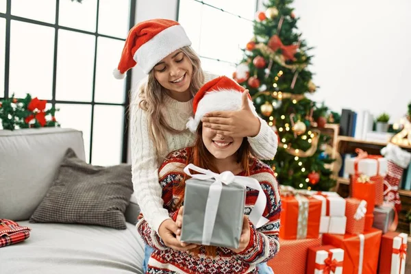 Woman Couple Surprise Gift Sitting Christmas Tree Home — Φωτογραφία Αρχείου