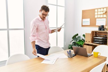 Young hispanic man working at office