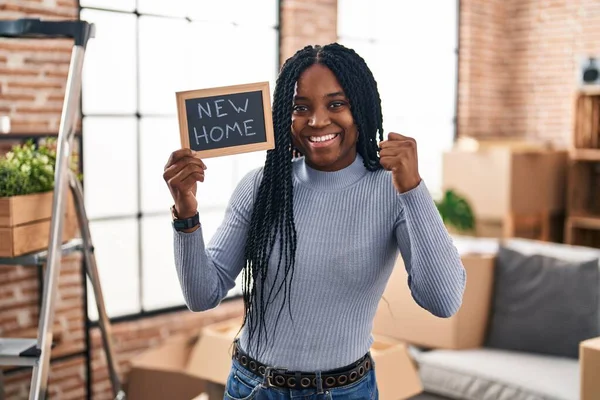 African American Woman Holding Blackboard New Home Text Screaming Proud — Stok fotoğraf