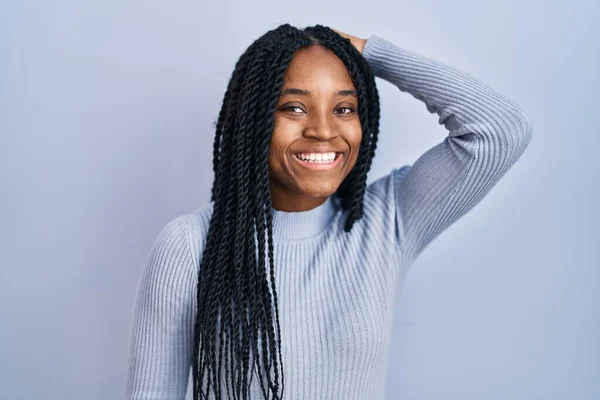 African American Woman Standing Blue Background Smiling Confident Touching Hair — Stockfoto