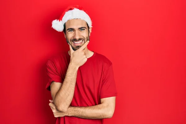 Young Hispanic Man Wearing Christmas Hat Looking Confident Camera Smiling — стоковое фото