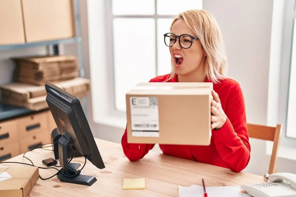 Blonde Woman Working Small Business Ecommerce Holding Box Angry Mad — Stockfoto