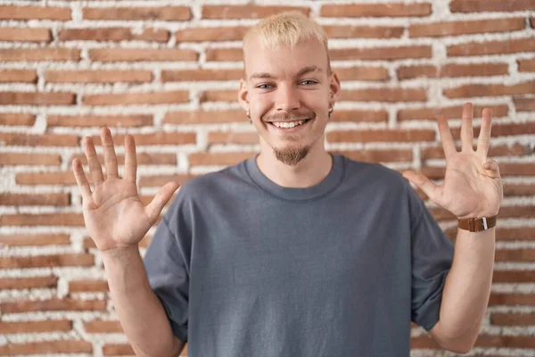 Young Caucasian Man Standing Bricks Wall Showing Pointing Fingers Number — Stockfoto