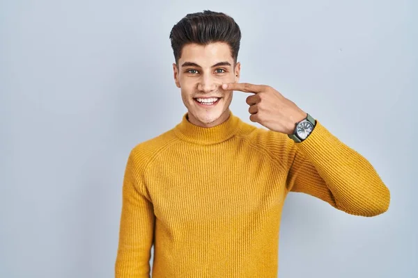 Young Hispanic Man Standing Blue Background Pointing Hand Finger Face — Stockfoto