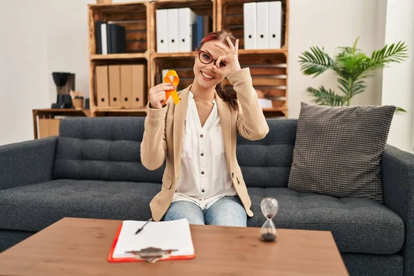 Young Caucasian Woman Holding Awareness Orange Ribbon Office Smiling Happy — Stockfoto