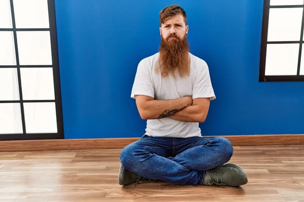 Redhead Man Long Beard Sitting Floor Empty Room Skeptic Nervous — Foto Stock