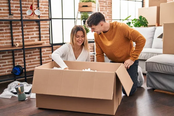 Young Man Woman Couple Smiling Confident Unpacking Cardboard Box New — Stock Photo, Image