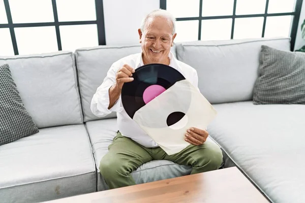 Senior Man Holding Vinyl Disc Sitting Sofa Home — Foto Stock