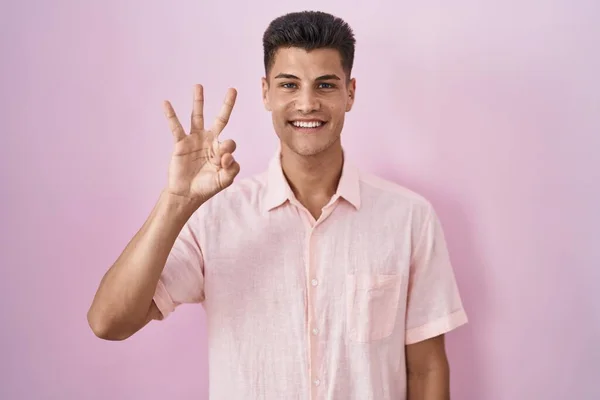 Young Hispanic Man Standing Pink Background Showing Pointing Fingers Number — 스톡 사진