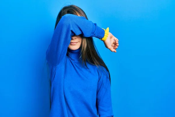 Young Brunette Girl Wearing Turtleneck Sweater Covering Eyes Arm Smiling — Stockfoto
