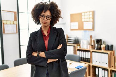 Young african american woman standing with arms crossed gesture at office