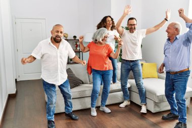 Bir grup orta yaşlı arkadaş evde dans ediyor..