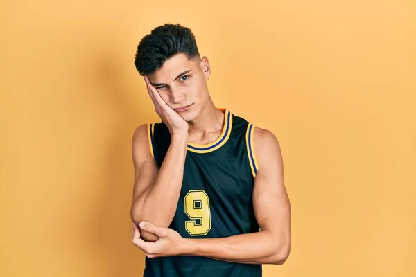 Young Hispanic Man Wearing Basketball Uniform Thinking Looking Tired Bored — Stockfoto