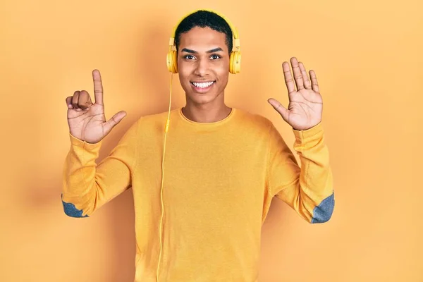 Young African American Guy Listening Music Using Headphones Showing Pointing — Stock Photo, Image