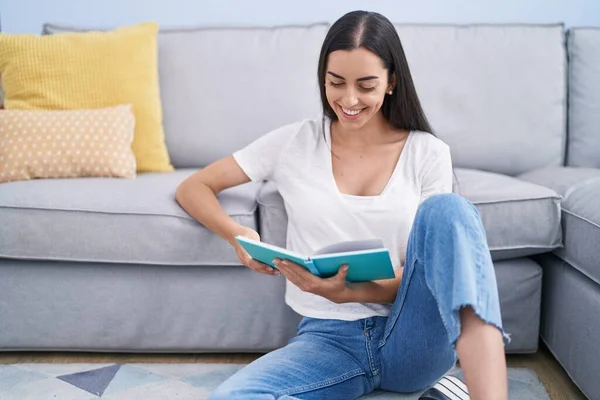 Young Hispanic Woman Reading Book Sitting Floor Home — Stockfoto