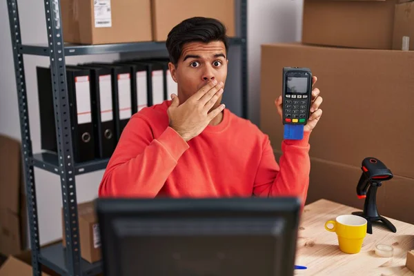 Hispanic Man Working Small Business Ecommerce Holding Dataphone Covering Mouth — Stock Photo, Image