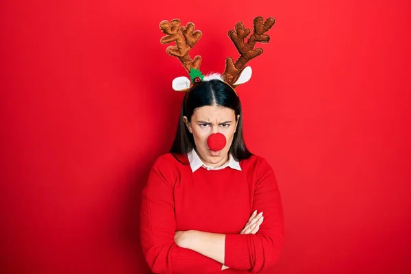 Young Hispanic Woman Wearing Deer Christmas Hat Red Nose Skeptic — стоковое фото