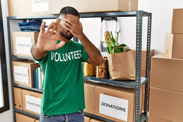 Young Indian Man Volunteer Holding Donations Box Covering Eyes Hands — Stockfoto
