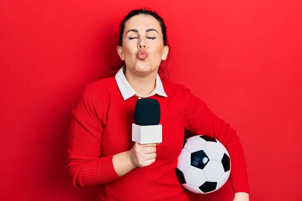 Young Hispanic Woman Holding Reporter Microphone Soccer Ball Looking Camera — ストック写真