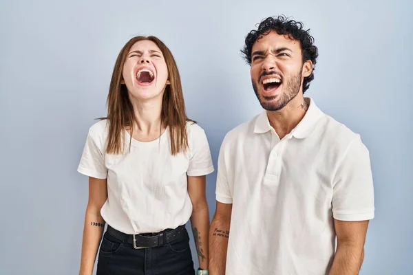 Young Couple Wearing Casual Clothes Standing Together Angry Mad Screaming —  Fotos de Stock