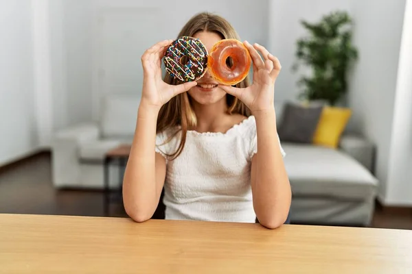 Adorable Girl Holding Donuts Eyes Sitting Table Home — Fotografia de Stock