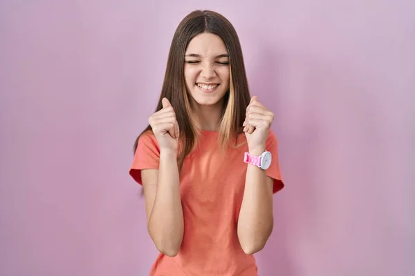 Teenager Girl Standing Pink Background Excited Success Arms Raised Eyes — Φωτογραφία Αρχείου