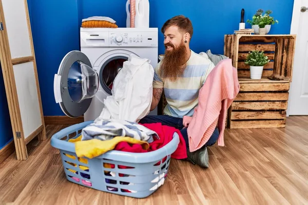 Young Redhead Man Smiling Confident Washing Clothes Laundry Room — стоковое фото