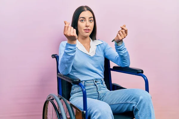 Beautiful Woman Blue Eyes Sitting Wheelchair Doing Money Gesture Hands — Foto Stock